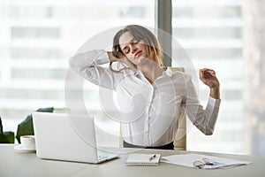 Exhausted businesswoman taking break from sedentary work stretch photo