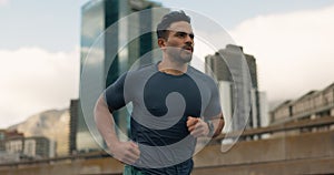 Exercise, running and a sports man in the city for cardio training to improve fitness for a marathon. Wellness, workout