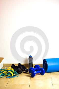 Exercise set at home dumbbell, yoga mat on white background. Fitness at home concept.