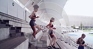 Exercise, stadium stairs and people running for cardio practice, group workout or sports team fitness. Arena, staircase