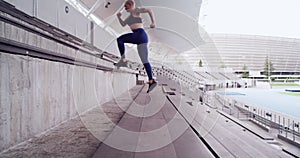 Exercise, stadium stairs or woman running for cardio practice, active workout or sports fitness. Arena, concrete