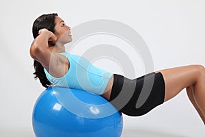 Exercise stomach crunches by athletic young woman photo