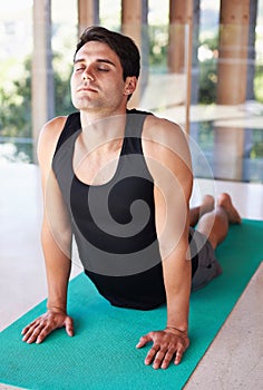 Exercise, stretching and man during yoga, fitness and workout at wellness center. Flexible, relax and mindset or