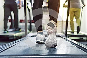 Exercise treadmill cardio running workout at fitness gym of woman taking weight loss with machine aerobic for slim and firm health photo