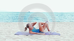 Exercise woman stretching on beach. Fitness sport model smiling happy stretching legs during outdoor work out on sunny