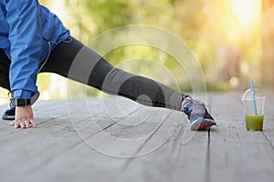 Exercise woman stretching hamstring leg muscles duing outdoor ru