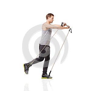 Exercise, workout and resistance band with a young man in studio isolated on a white background for health. Gym, fitness