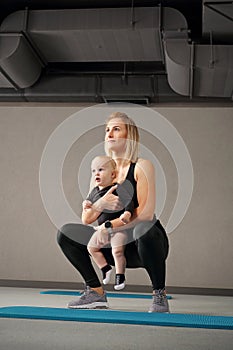 Exercises with the child. Mom trains fitness with a small child.