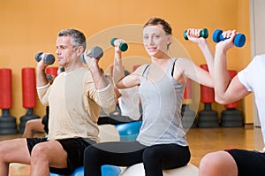 Exercising with fitness ball at gym