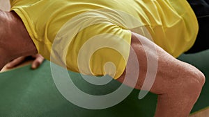 Exercising at home. Cropped shot of a strong man fitness instructor in sportswear doing push ups on yoga mat indoors