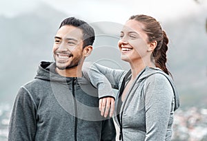 Exercising improves our mood and mental energy too. a sporty young man and woman exercising outdoors.