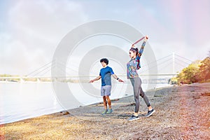 Exercising- Sports couple training outdoors -Woman working out with resistance bands