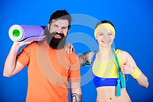 Exercising together is fun. Healthy lifestyle concept. Man and woman exercising with yoga mat and jump rope. Fitness