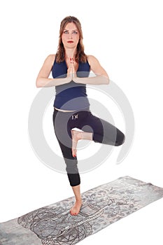 Exercising woman standing on one leg