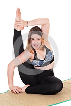 Exercising young woman sitting on the floor