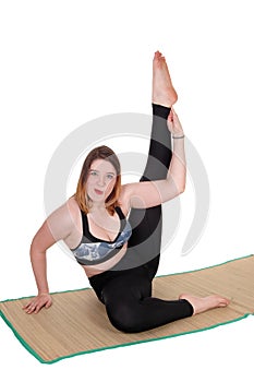 Exercising young woman sitting on the floor