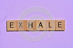 Exhale, word on mauve background