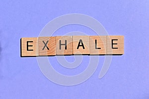 Exhale, word on purple background