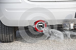 Exhaust from a car with the traffic sign for driving ban, in ger photo