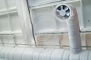 Exhaust fan of the ventilation system on the concrete ceiling of an industrial building.