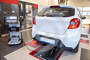 Exhaust gas measurement at a diagnostic station in a passenger car photo