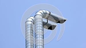 Exhaust pipes against blue sky