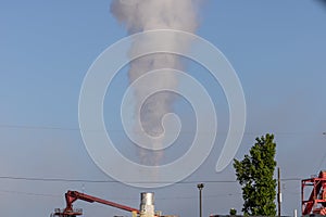 Exhaust stack blowing steam from factory