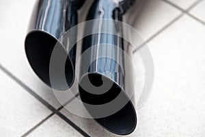 Exhaust system with a double black nozzle on the pipe to increase the power of the car and tuning in the workshop for the