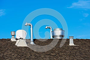 Exhaust system vent and grease trap on wooden roof of a restaurant