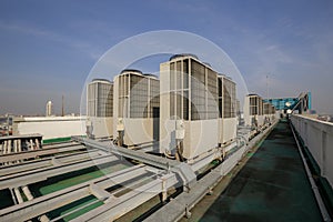 Exhaust vents of industrial air conditioning and ventilation units. Skyscraper roof top from high building