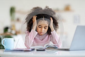 Exhausted african american child schooler doing homework