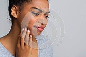 Exhausted afro girl suffering from strong pulpitis