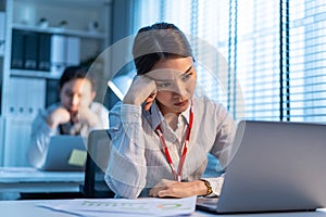 Exhausted Asian sick business woman worker working on table in office. Busy Employee people feel tired and headache from late of