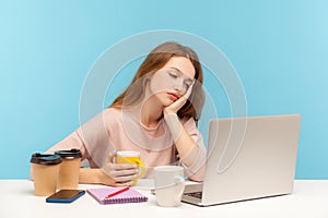 Exhausted bored woman, office employee surrounded by coffee cups in workplace, looking at laptop screen with indifferent face