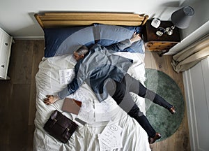 Exhausted business man falling asleep as soon as he came back home