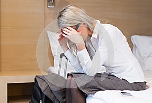 Exhausted business woman in hotel room