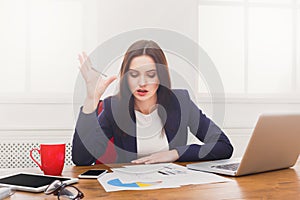 Exhausted business woman at workplace, deadline