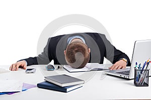 Exhausted businessman falling asleep at his office desk