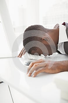 Exhausted businessman napping on keyboard