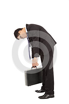 Exhausted businessman stoop and holding briefcase