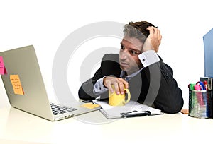 Exhausted businessman suffering stress at office computer desk overwhelmed tired
