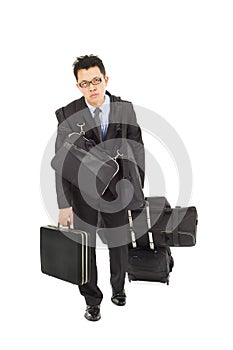 Exhausted businessman taking all bags
