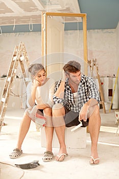 Exhausted couple in renovating home