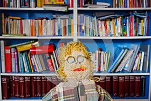 Exhausted Crocheted Male Engineer Doll: Blond Curls, Mustache, Plaid Shirt, and Glasses - Ingenious Concept Image of a Fatigued