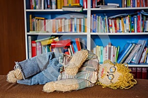 Exhausted Crocheted Male Engineer Doll: Blond Curls, Mustache, Plaid Shirt, and Glasses - Ingenious Concept Image of a Fatigued