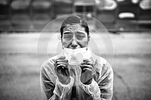 Exhausted crying doctor/nurse in coronavirus protective gear N95 mask.Covid-19 pandemic outbreak.Fatalities grief.Frontline worker photo