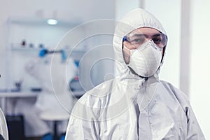 Exhausted doctor equipped with ppe suit looking at camera photo