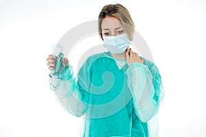 Exhausted Doctor holding medical ventilator after shift in the coronavirus intensive care unit