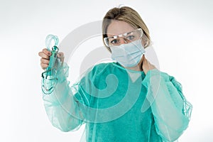 Exhausted Doctor holding medical ventilator after shift in the coronavirus intensive care unit