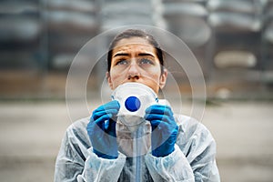 Exhausted doctor/nurse wearing coronavirus protective gear N95 mask uniform.Coronavirus Covid-19 outbreak.Mental stress of photo